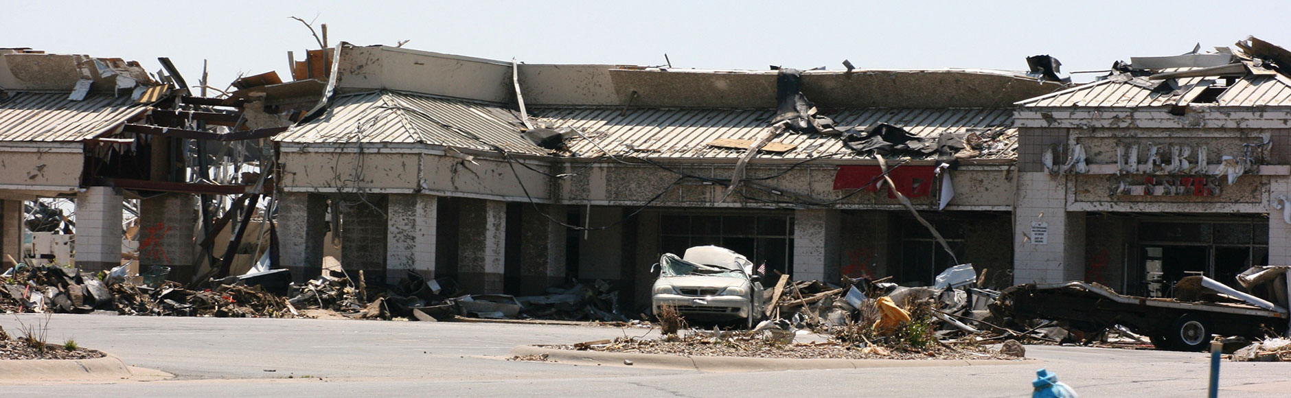 Car and building damaged by tornado