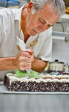 baker decorating cake